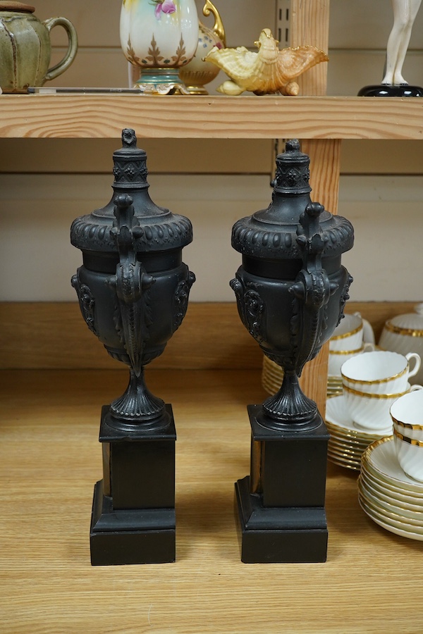 A pair of Victorian black metal and marble mantel clock garnitures, 45cm high. Condition - good